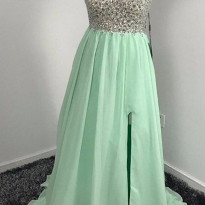 A Green Chiffon Ball Gown With A V-neck And..