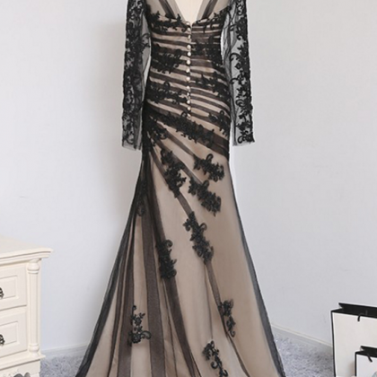 A Black, Elegant Evening Gown With A Mermaid Tulle..